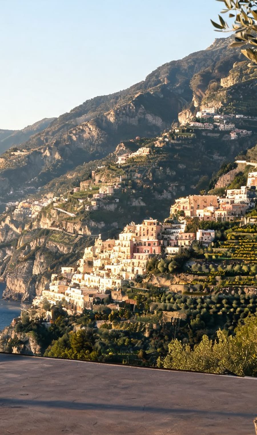 Pastel houses stacked down the cliff to the sea on the Amalfi Coast