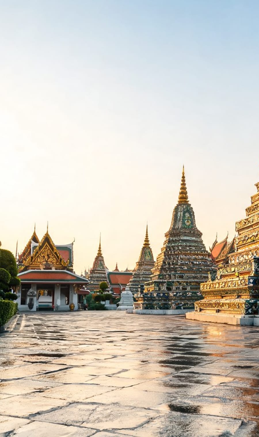 Gilded chedis and temple roofs of a Bangkok wat after rain